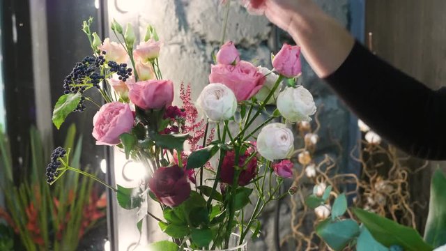 Florist woman making a bouquet of fresh beautiful flowers. 4K