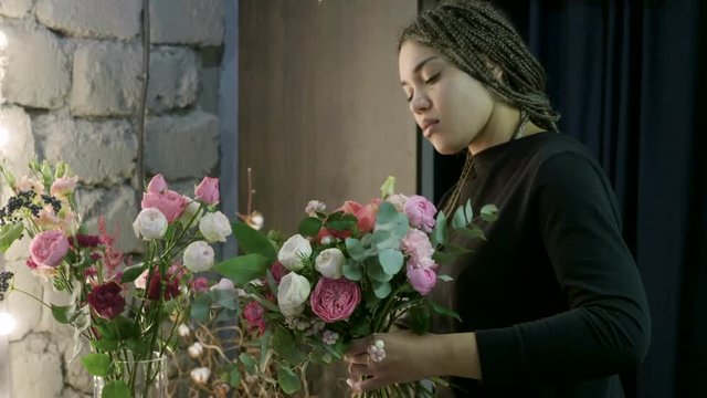 Florist woman making a bouquet of fresh beautiful flowers. 4K
