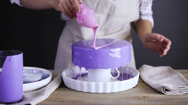 Step by step. Pastre shef glazing mousse cake with purple mirror glaze