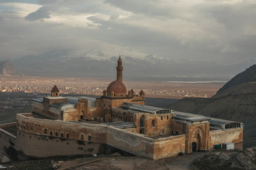 former persian palace in mountain landscape at sunset, ishak pasha palace, dogubayazit, turkey