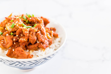 fried pork with spicy korean sauce (bulgogi) on top rice