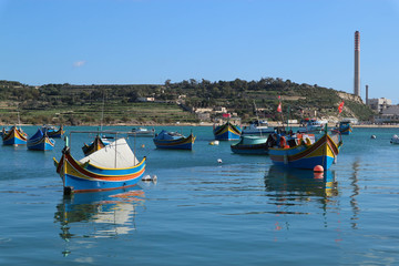 Traditional maltese fisherman boat luzzu in Marsaxlokk bay, Malta
