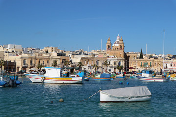 Fototapeta na wymiar Traditional maltese fisherman boat luzzu in Marsaxlokk bay, Malta
