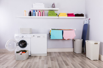 Basket Full Of Dirty Clothes In Laundry Room