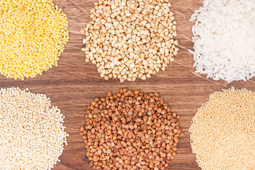 Gluten free white rice and groats on rustic board, healthy nutrition