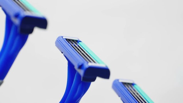 Disposable blue razors closeup. Smooth rotation.