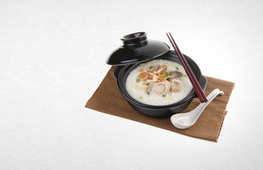 Porridge or abalone porridge in claypot on a background.