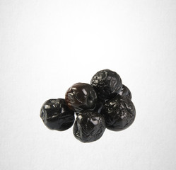 Dried preserved or Black Plums on a background.