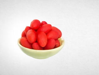 Dried preserved red canarium album on a background.