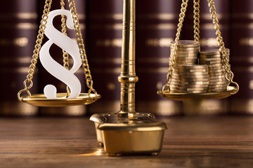 Paragraph Symbol And Stacked Coins On Justice Scale