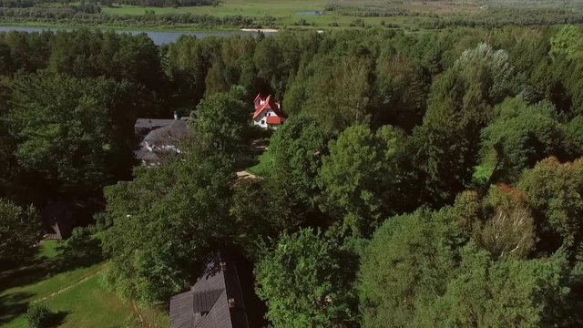 Shooting from a helicopter, the suburban real estate. Cottage village in the forest 4K