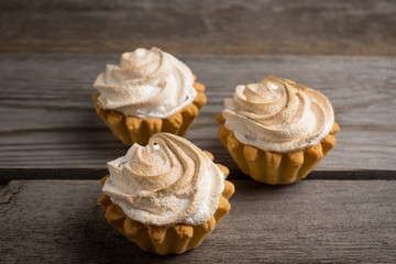 Creamy cake on the rustic background. Selective focus.
