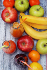 Juice Glasses of freshly Fruit juice with colorful fruits on Rustic Gray wooden Background. Healthy Food Concept.