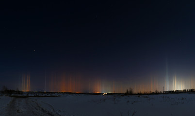 Multicolored radiance in the atmosphere. Natural phenomenon in the night sky over the highway.