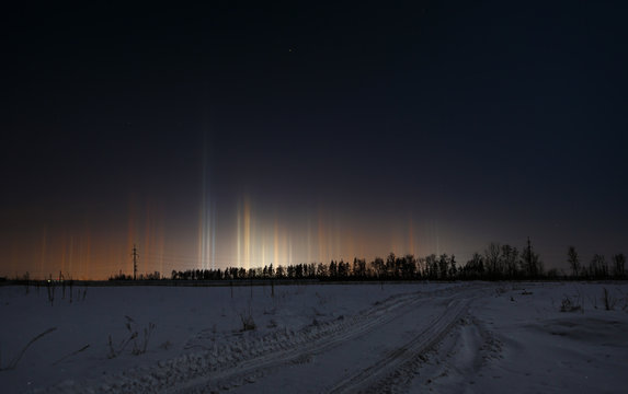 Multicolored radiance in the atmosphere. Natural phenomenon in the night sky over the highway.