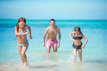 Father and little kids enjoying beach summer tropical vacation