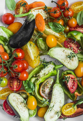 Mix raw seasonal vegetables cooking. Eggplant, bell pepper, tomatoes, carrots, zucchini, cherry tomatoes, spices, olive oil close up. Weight loss, diet vegetarian food concept. Flat lay