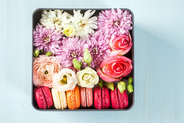 Box with various flowers and macarons