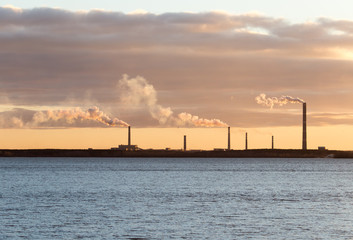 Smoke from the pipes of an industrial plant in the morning