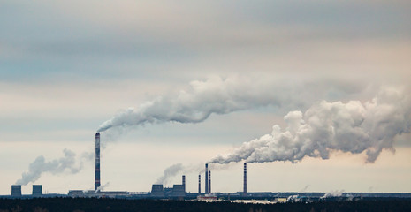 Smoke from the pipes of an industrial plant in the morning