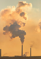 Smoke from the pipes of an industrial plant in the morning