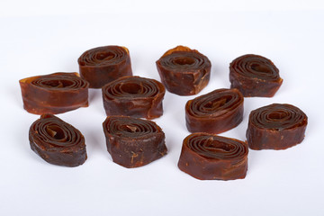 Home made apple and plum fruit pastille rolls. Isolated on white background. Healthy kids food and snack, natural ingredients