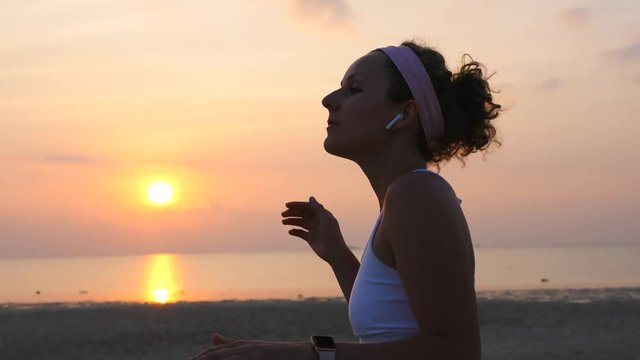 Sport Woman Dancing Listening Music In Wireless Earphones Airpods At Sunset Beach