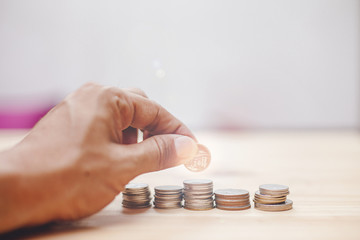 Coin and hand money saving concept, Coin put to stack by man hand for business finnace concept
