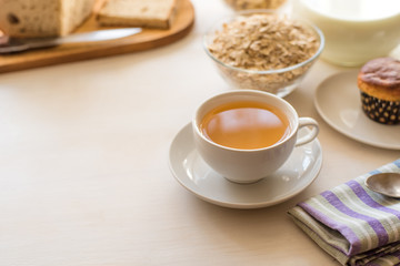 Healthy breakfast. Oatmeal, tea and fresh pastries - copy space, top view. Natural lighting