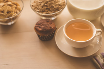 Healthy breakfast. Oatmeal, tea and fresh pastries - copy space, top view. Natural lighting
