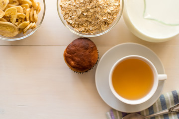 Healthy breakfast. Oatmeal, tea and fresh pastries - copy space, top view. Natural lighting