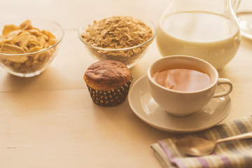 Healthy breakfast. Oatmeal, tea and fresh pastries - copy space, top view. Natural lighting