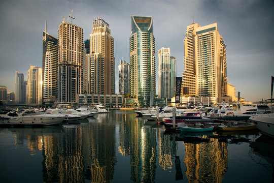 DUBAI, UAE - FEBRUARY 2018: View of modern skyscrapers shining in sunrise lights  in Dubai Marina in Dubai, UAE.