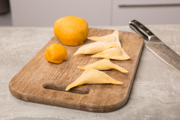Ravioli homemade. Fresh dough and ravioli traditional to the wooden cutting board. cooking process