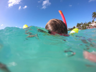 View of girl's head snorkeling in caribbean sea