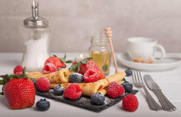 pancakes with fresh fruits, strawberry, raspberry, honey and coffee