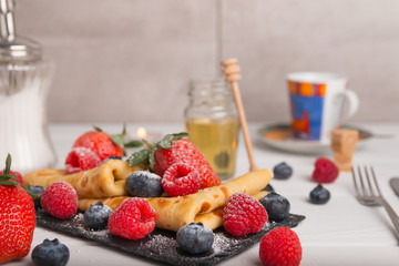 pancakes with fresh fruits, strawberry, raspberry, honey and coffee