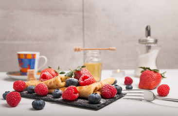 pancakes with fresh fruits, strawberry, raspberry, honey and coffee