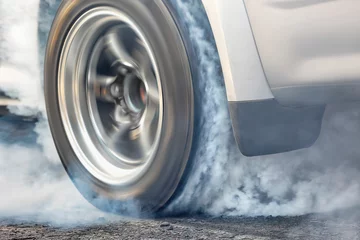 Fototapeten Drag racing car burns rubber off its tires in preparation for the race © toa555
