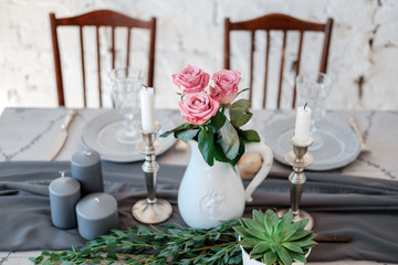 Decoration of the table. Bouquet of pink roses in a vase