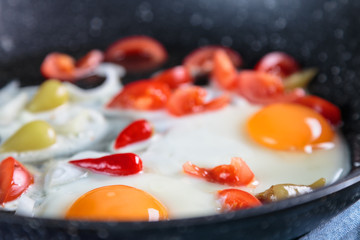 Сooking fried eggs. The ingredients are laid out in a griddle.