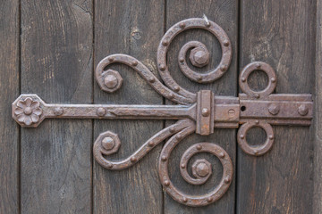 Iron rusty lock on the close old wooden door of ancient French church