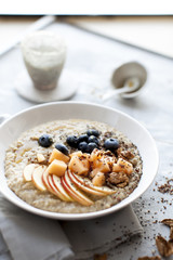 morning oat porridge with fresh fruits and tea