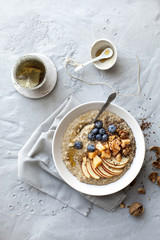 morning oat porridge with fresh fruits and tea