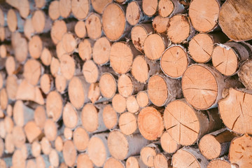 Pile firewood prepared for fireplace. Wooden background - closeup.