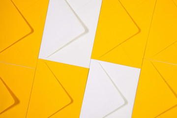 White and yellow envelopes on the  table - obrazy, fototapety, plakaty