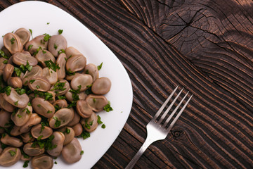 boiled broad beans on a rustic background