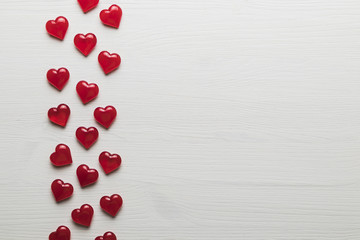 background of red hearts on a white wooden substrate