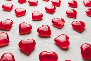 background of red hearts on a white wooden substrate