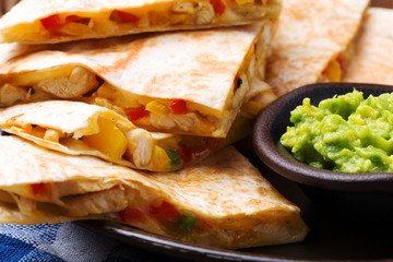 Quesadilla with chicken, served with guacamole or salsa sauce.